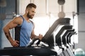 Young handsome man running on treadmill at gym Royalty Free Stock Photo