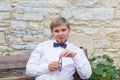 Young handsome man with short hair wearing a bow tie and posing in the city streets. Royalty Free Stock Photo