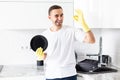 Young handsome Man showing okay after washing dishes in the kitchen Royalty Free Stock Photo