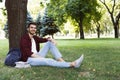 Young handsome man sitting on grass outdoors Royalty Free Stock Photo