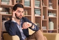 Young handsome man sitting looking watch Royalty Free Stock Photo