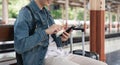 Young handsome man sitting and using smartphone at train station Royalty Free Stock Photo