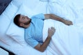 Young handsome man sleeping in bed at night Royalty Free Stock Photo