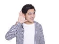 Young handsome man  smiling and making listening gestures.Isolated on white background Royalty Free Stock Photo