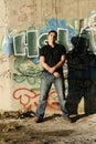 Young handsome man standing by the graffiti wall Royalty Free Stock Photo