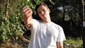 Young man in nature doing thumb down sign Royalty Free Stock Photo