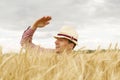 Young handsome happy man standing in wheat field spreading his arms up Royalty Free Stock Photo