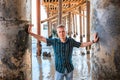 Young handsome man stands under a wooden pier on Malibu beach, California Royalty Free Stock Photo