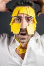 Young handsome man with sticky notes on his face Royalty Free Stock Photo