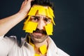 Young handsome man with sticky notes on his face Royalty Free Stock Photo