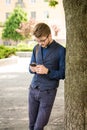 Young handsome man in the street with a phone in his hands Royalty Free Stock Photo