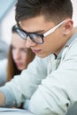 Young handsome man student sitting in classroom Royalty Free Stock Photo