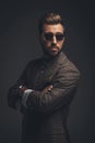 Young handsome man in suit and sunglasses standing with arms crossed, Royalty Free Stock Photo