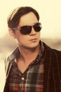 Young handsome man in sunglasses and black blazer Royalty Free Stock Photo