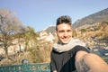 Young handsome man taking selfie by Passer river at Meran city Royalty Free Stock Photo
