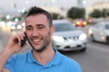 Young handsome man talking on his smart phone, traffic jam in background with copy space Royalty Free Stock Photo