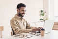 Young handsome man using laptop at home, Businessman or student working online on computer indoors Royalty Free Stock Photo