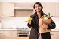 The young handsome man with vegetables in the kitchen Royalty Free Stock Photo