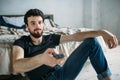 Young handsome man watching TV on a floor at home Royalty Free Stock Photo