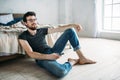 Young handsome man watching TV on a floor at home Royalty Free Stock Photo