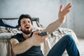 Young handsome man watching TV on a floor at home Royalty Free Stock Photo