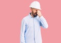 Young handsome man wearing architect hardhat tired rubbing nose and eyes feeling fatigue and headache Royalty Free Stock Photo