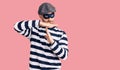 Young handsome man wearing burglar mask doing time out gesture with hands, frustrated and serious face Royalty Free Stock Photo