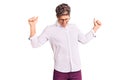 Young handsome man wearing business clothes and glasses dancing happy and cheerful, smiling moving casual and confident listening Royalty Free Stock Photo