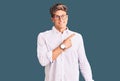 Young handsome man wearing business clothes and glasses pointing aside worried and nervous with forefinger, concerned and Royalty Free Stock Photo