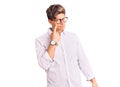 Young handsome man wearing business clothes and glasses pointing to the eye watching you gesture, suspicious expression Royalty Free Stock Photo