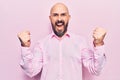 Young handsome man wearing business clothes screaming proud, celebrating victory and success very excited with raised arms Royalty Free Stock Photo