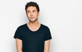 Young handsome man wearing casual black t shirt smiling looking to the side and staring away thinking Royalty Free Stock Photo