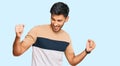 Young handsome man wearing casual clothes dancing happy and cheerful, smiling moving casual and confident listening to music Royalty Free Stock Photo