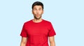 Young handsome man wearing casual red tshirt making fish face with lips, crazy and comical gesture Royalty Free Stock Photo