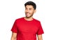 Young handsome man wearing casual red tshirt smiling looking to the side and staring away thinking Royalty Free Stock Photo