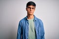 Young handsome man wearing casual shirt and glasses over isolated white background depressed and worry for distress, crying angry Royalty Free Stock Photo