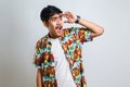 Young handsome man wearing casual shirt looking away to side with smile on face, natural expression Royalty Free Stock Photo