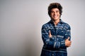 Young handsome man wearing casual shirt standing over isolated white background happy face smiling with crossed arms looking at Royalty Free Stock Photo