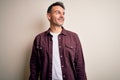 Young handsome man wearing casual shirt standing over isolated white background looking away to side with smile on face, natural Royalty Free Stock Photo