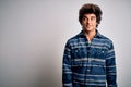 Young handsome man wearing casual shirt standing over isolated white background smiling looking to the side and staring away Royalty Free Stock Photo