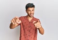 Young handsome man wearing casual summer clothes pointing to you and the camera with fingers, smiling positive and cheerful Royalty Free Stock Photo