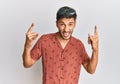 Young handsome man wearing casual summer clothes shouting with crazy expression doing rock symbol with hands up Royalty Free Stock Photo