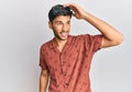 Young handsome man wearing casual summer clothes smiling confident touching hair with hand up gesture, posing attractive and Royalty Free Stock Photo