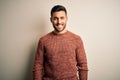 Young handsome man wearing casual sweater standing over isolated white background with a happy and cool smile on face Royalty Free Stock Photo