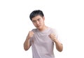 Young handsome man wearing casual t-shirt over white background. Punching fist to fight, aggressive and angry attack, threat and Royalty Free Stock Photo