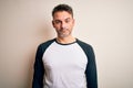 Young handsome man wearing casual t-shirt standing over isolated white background depressed and worry for distress, crying angry Royalty Free Stock Photo