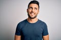 Young handsome man wearing casual t-shirt standing over isolated white background looking away to side with smile on face, natural Royalty Free Stock Photo