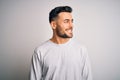 Young handsome man wearing casual t-shirt standing over isolated white background looking away to side with smile on face, natural Royalty Free Stock Photo