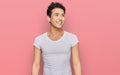 Young handsome man wearing casual white t shirt looking away to side with smile on face, natural expression Royalty Free Stock Photo