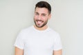 Young handsome man wearing casual white t-shirt over isolated background looking away to side with smile on face, natural Royalty Free Stock Photo